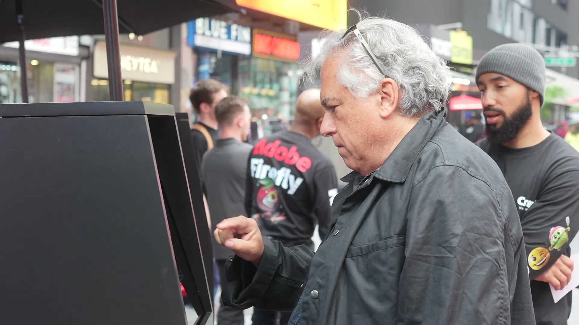 Visitor using a self-service Adobe Firefly station in the Times Square activation