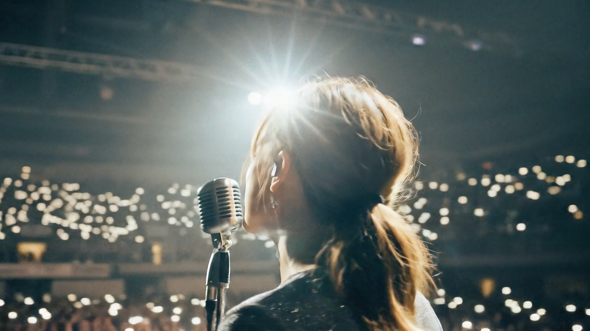 Veo example frame from a first-and-last-frame camera move ending behind a singer on stage