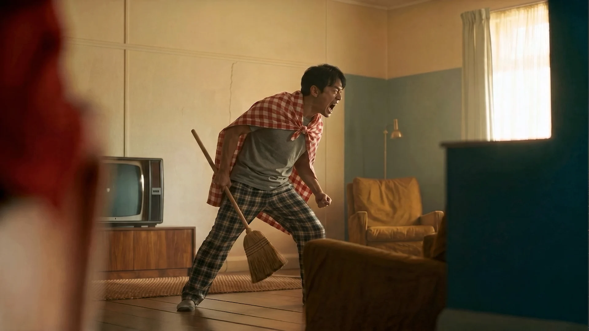 Human performer holding a broom like a weapon in a filmed source performance for an Autodesk Flow Studio demo