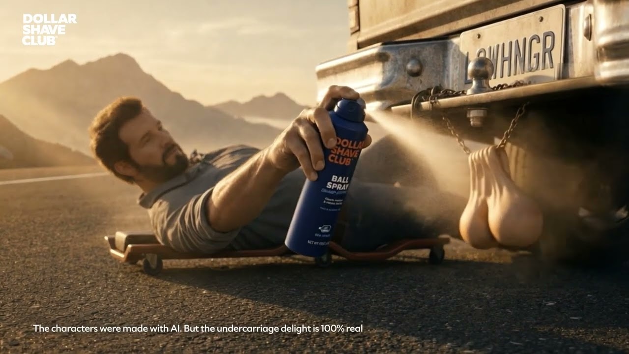 Dollar Shave Club Ball Spray ad frame showing a synthetic mechanic spraying truck ornaments with an on-screen AI disclosure