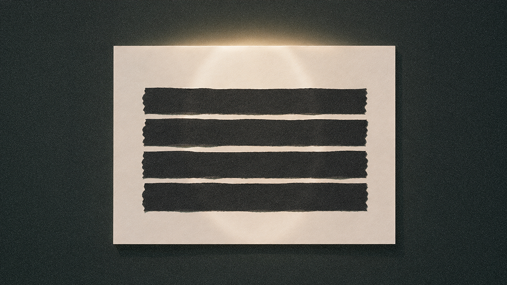Four black bars blocking text on an illuminated sheet of paper