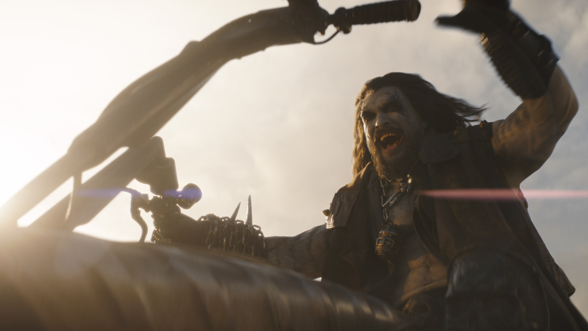 Jason Momoa wearing the completed Lobo costume and makeup while riding his motorcycle in Supergirl