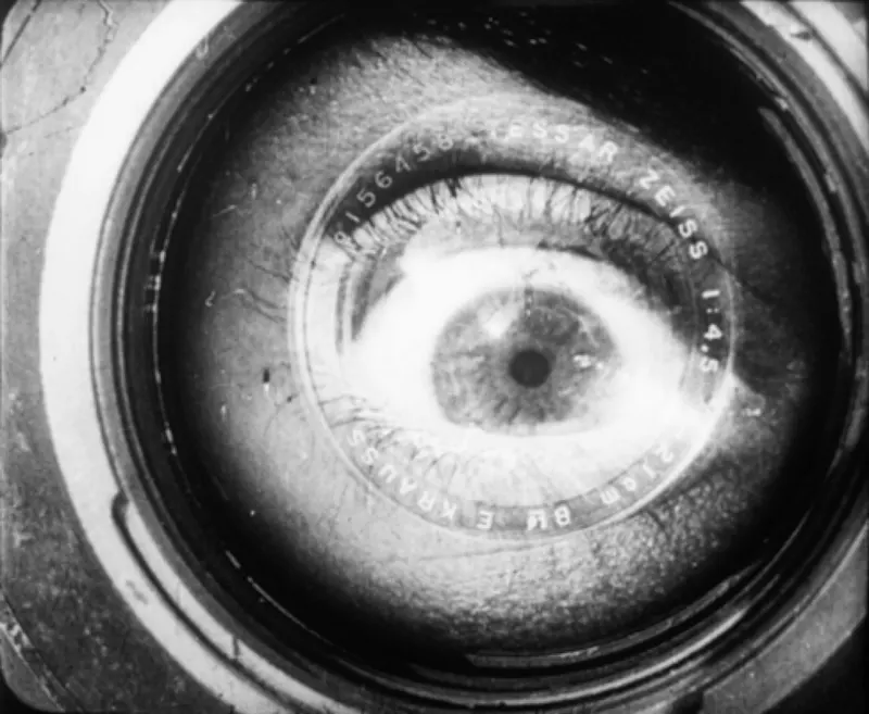Public-domain frame from Man with a Movie Camera showing a camera operator and film apparatus