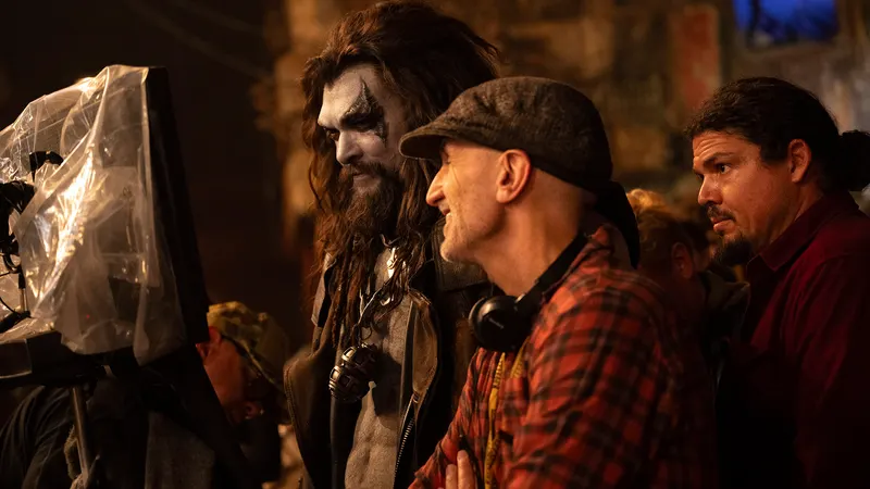 Jason Momoa in Lobo costume and director Craig Gillespie reviewing a production monitor on the set of Supergirl