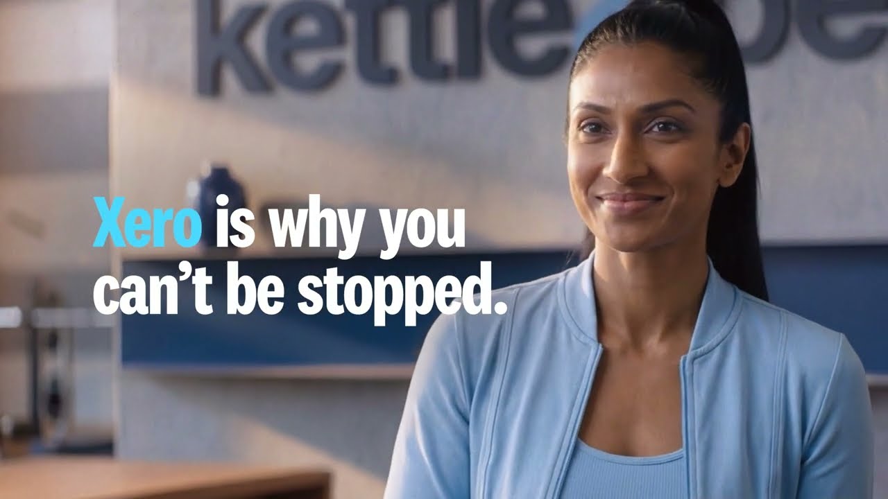 Woman in a gym reception setting beside Xero campaign typography